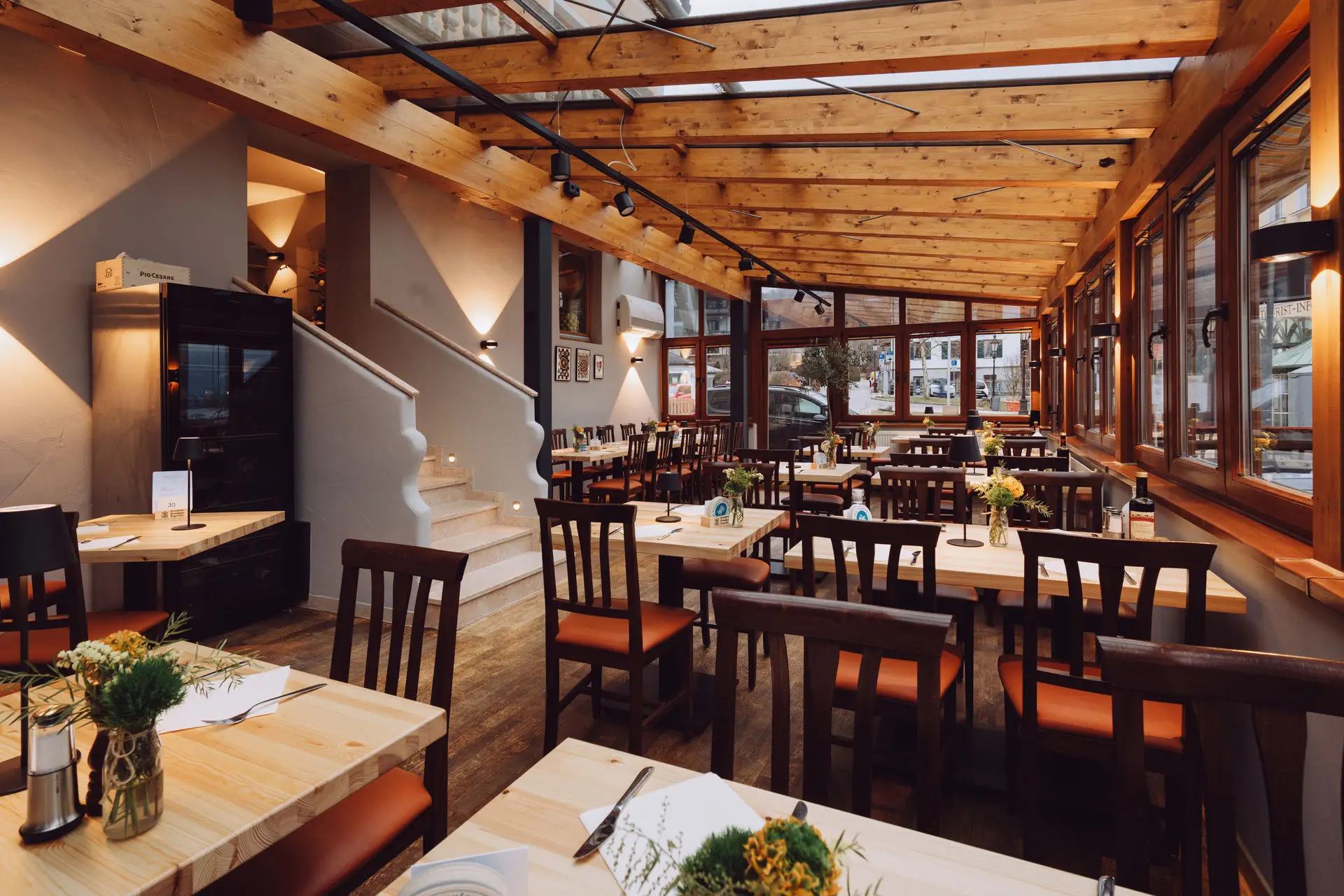 The bright dining room at Mamma Clara with tables set for guests