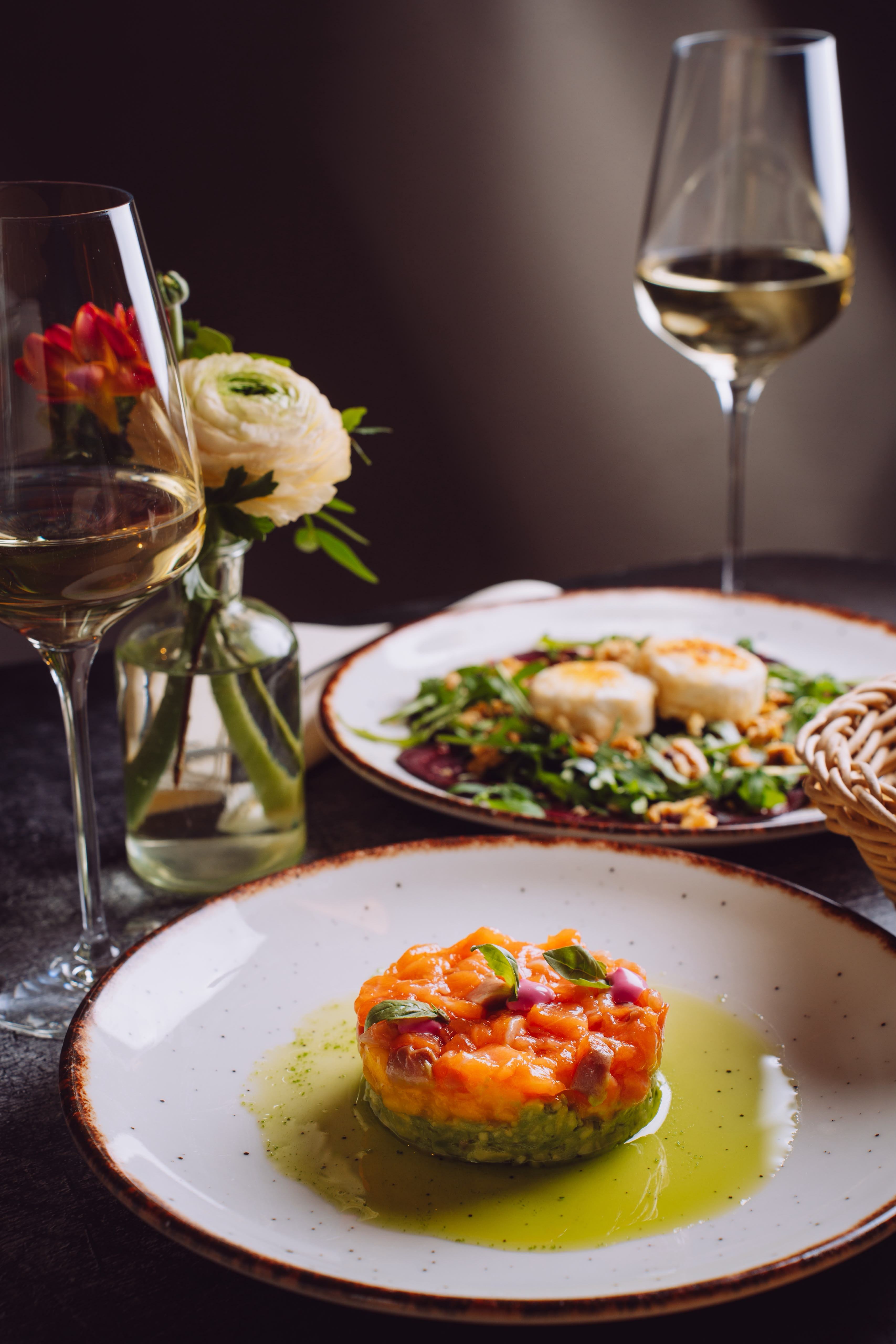 A set table with Italian dishes, flowers and wine
